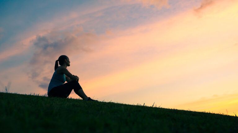 Woman sitting on a hill