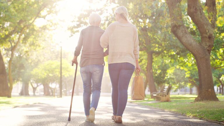 Adult woman and senior mother on an outdoor walk