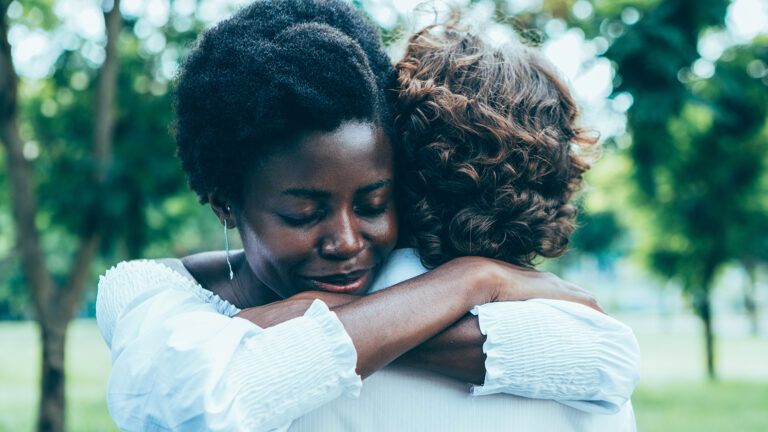 Woman hugging another person