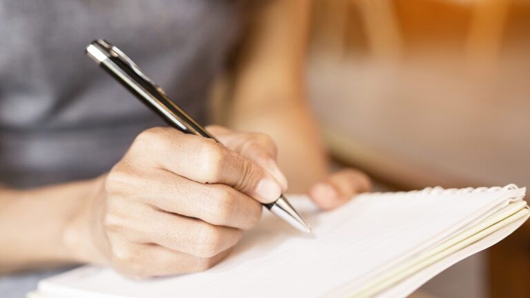 Woman writing in notebook