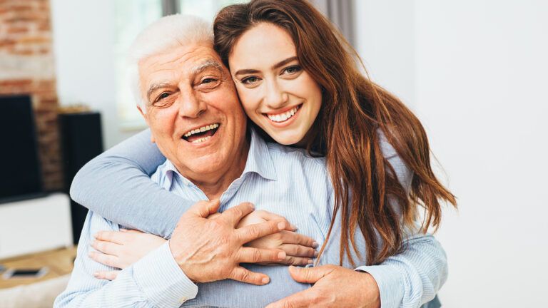 Woman hugging her senior father