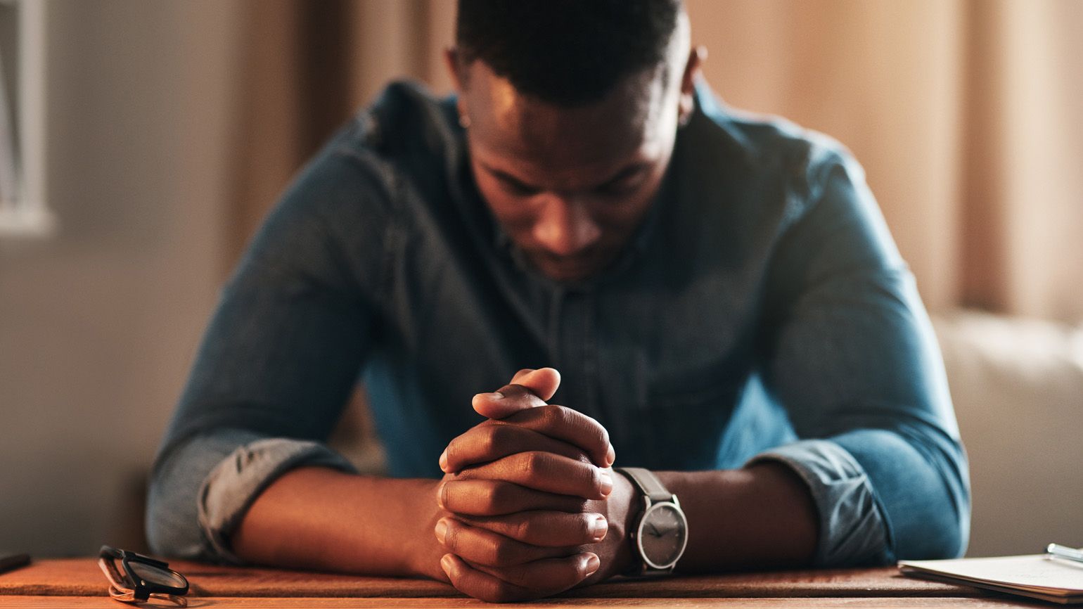 Man in prayer; Getty Images