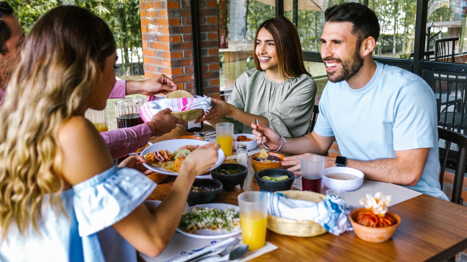 Family group having a meal; Getty Images