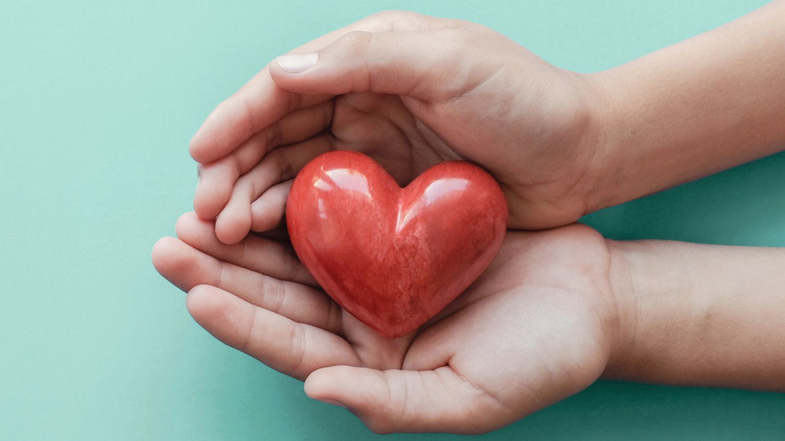 Hands holding a heart figure; Getty Images