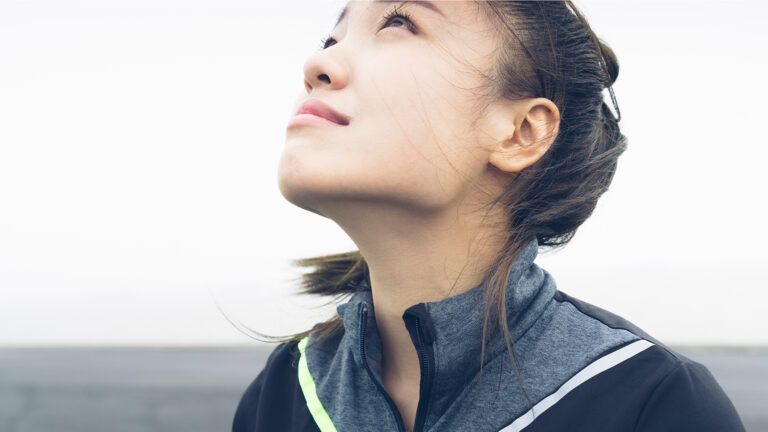 Woman looking upward towards the sky