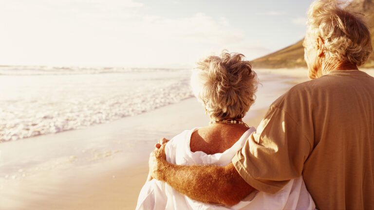 Senior couple walking on the beach