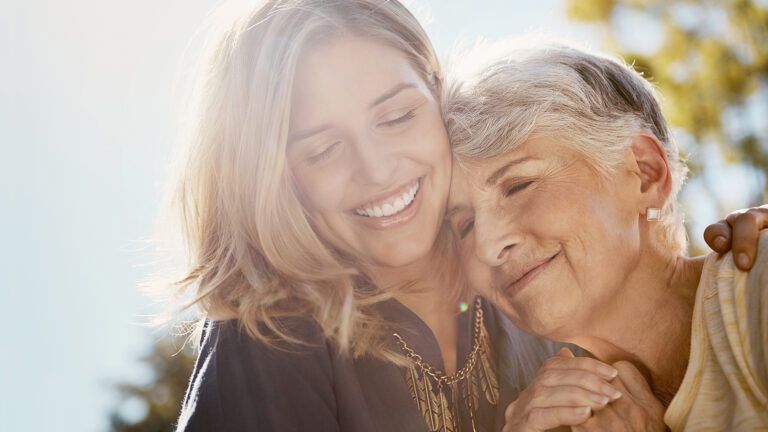 Woman hugging senior