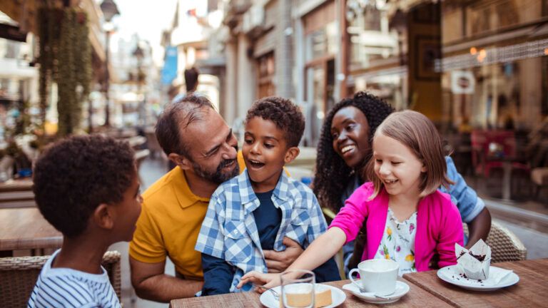 Blended family sitting together at a cafe looking for tips for blended families