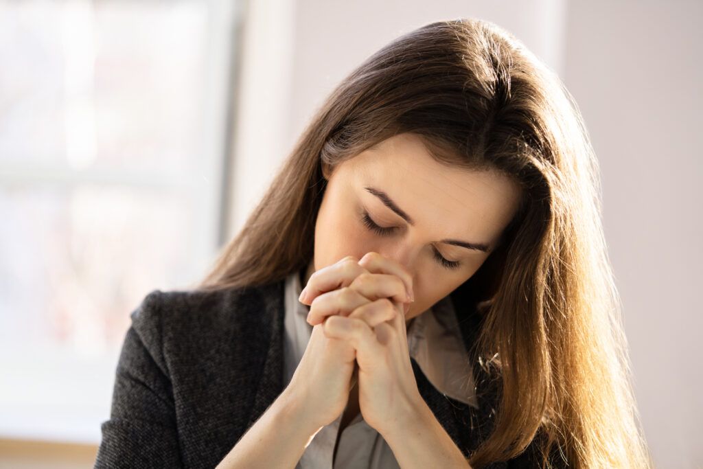 Woman praying in the morning light