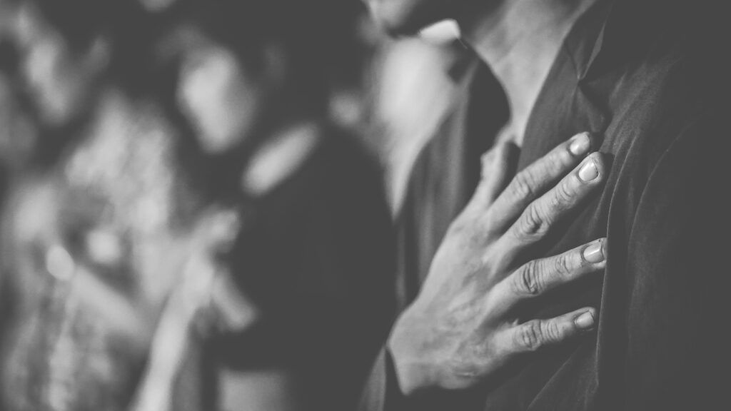 Man holding hand over heart; Getty Images