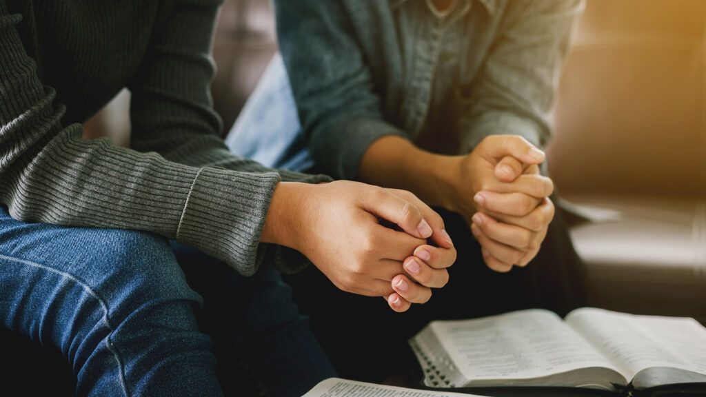 A married couple prays