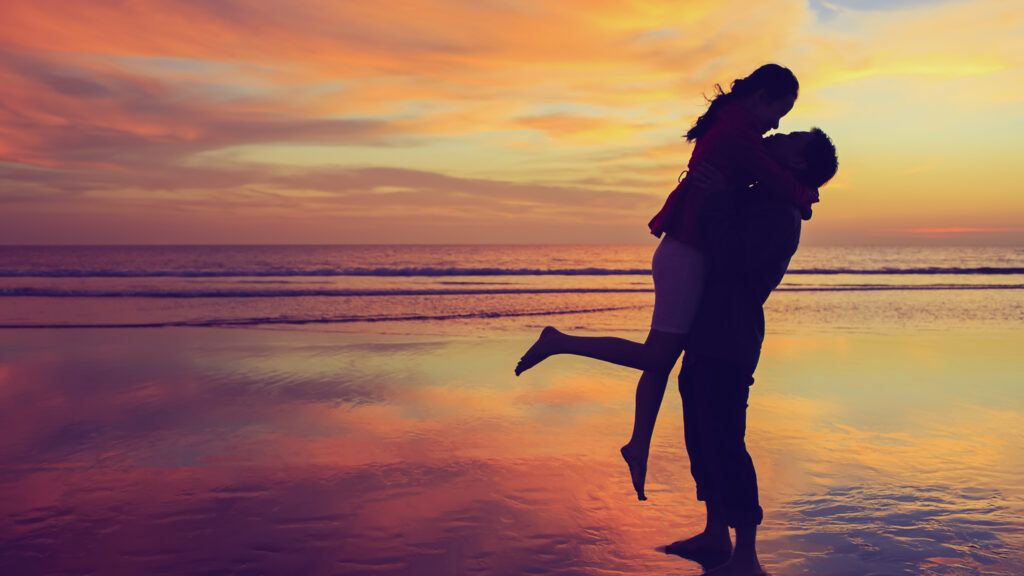 Couple in silhouette on the beach in their true love story