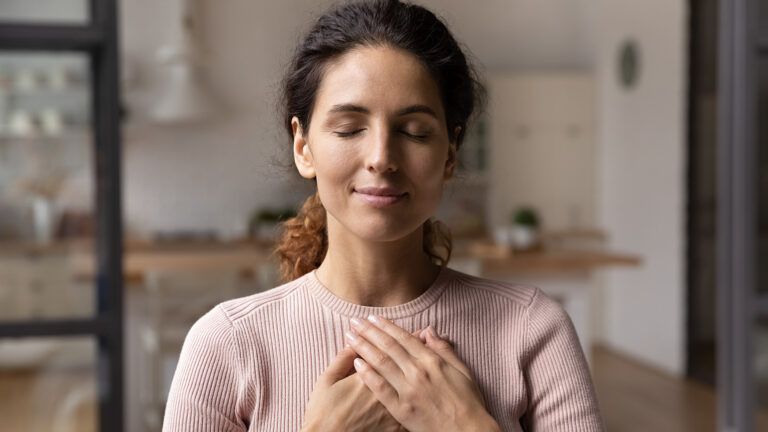 Young woman praying during Lenten season; Getty Images