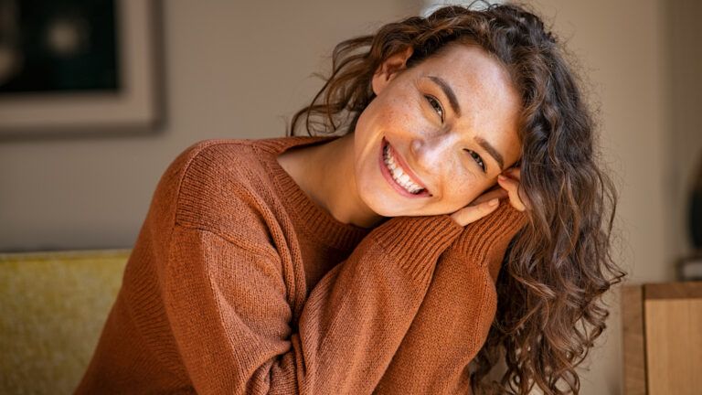 A smiling, confident young woman shows inner strength