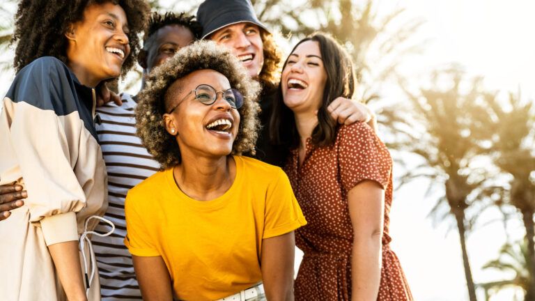 Group of friends laughing together. Key to lifelong happiness.